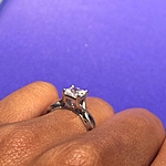 This image shows the setting with a .85ct princess cut center diamond. 