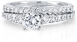 This image shows the setting with a 1.00ct round brilliant cut center diamond and the matching wedding band; sold separately.