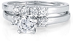This image shows the setting with a 1.00ct round brilliant cut center diamond and the matching wedding band; sold separately.