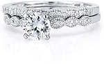 This image shows the setting with a 1.00ct round brilliant cut center diamond and the matching wedding band; sold separately.