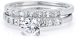 This image shows the setting with a 1.00ct round brilliant cut center diamond and the matching wedding band; sold separately.