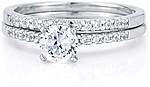 This image shows the setting with a 1.00ct round brilliant cut center diamond and the matching wedding band; sold separately.