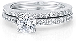 This image shows the setting with a 1.00ct round brilliant cut center diamond and the matching wedding band; sold separately.