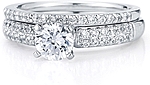 This image shows the setting with a 1.00ct round brilliant cut center diamond and the matching wedding band; sold separately.