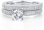 This image shows the setting with a 1.00ct round brilliant cut center diamond and the matching wedding band; sold separately.
