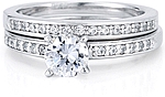 This image shows the setting with a 1.00ct round brilliant cut center diamond and the matching wedding band; sold separately.