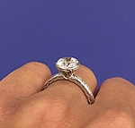 This image shows the setting with a 1.50ct round cut center diamond. 